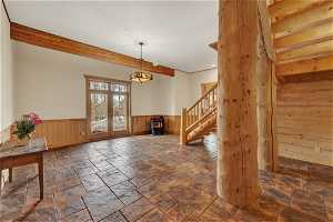 Foyer with french doors, a wood stove, and tile floors