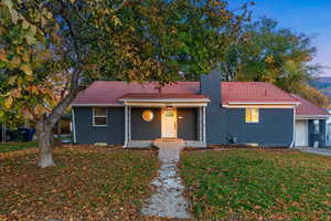 View of front facade with a garage and a lawn