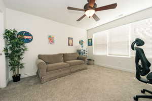 Bedroom #3 with plenty of natural light, carpet floors, and ceiling fan. Being used as an office.