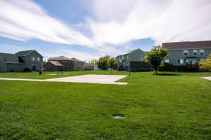 View of yard featuring basketball hoop