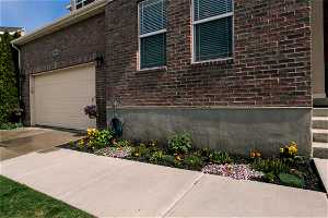 View of side of home featuring flower bed.