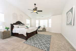 Carpeted Master with vaulted ceiling and ceiling fan