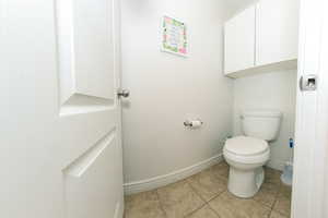 Master Bathroom featuring private lavatory and tile flooring