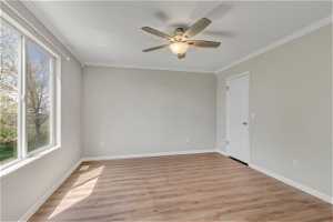 Spare room featuring ornamental molding, light hardwood / wood-style floors, and ceiling fan