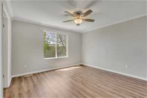 Unfurnished room with ornamental molding, ceiling fan, and hardwood / wood-style floors