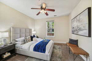 Carpeted bedroom with ceiling fan