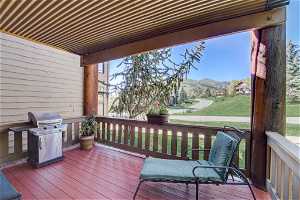 Wooden deck with area for grilling and a mountain view