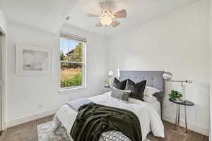 Bedroom featuring ceiling fan and carpet