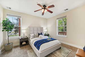 Bedroom featuring ceiling fan and carpet flooring