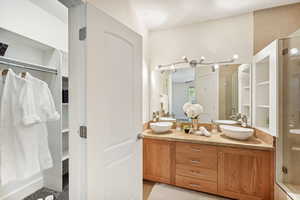 Bathroom featuring an enclosed shower and vanity