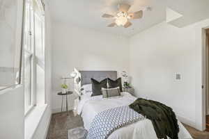 Bedroom with ceiling fan and carpet floors