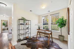 Office area with hardwood / wood-style floors