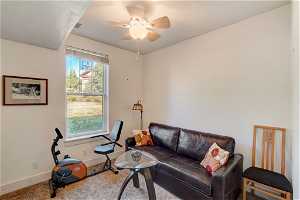 Sitting room with ceiling fan and carpet flooring