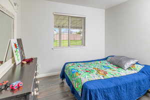 Bedroom with dark wood-type flooring