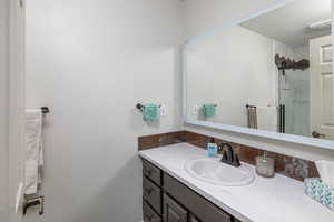 Bathroom featuring a shower and oversized vanity