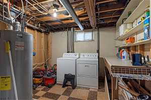Clothes washing area with independent washer and dryer, tile floors, and water heater
