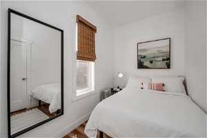 Bedroom featuring hardwood / wood-style flooring and radiator heating unit