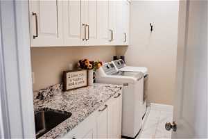 Laundry room with storage and sink