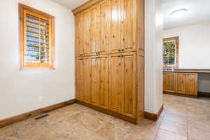 Interior space featuring light tile flooring and sink