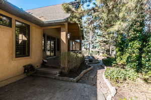 View of exterior entry featuring a patio area