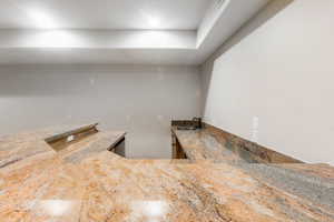 Kitchen with sink and light stone counters