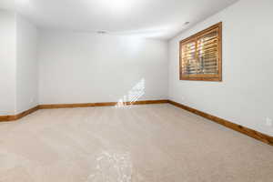 Unfurnished room featuring light colored carpet