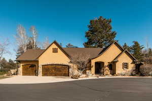 French provincial home with a garage