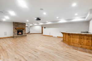 Unfurnished living room with a fireplace and light wood-type flooring