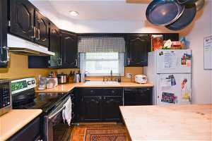 Kitchen with sink, stainless steel appliances, and tile flooring