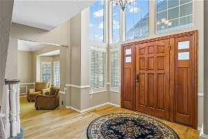Large entry with hardwood flooring and solid wood door.