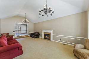 Formal living room with vaulted ceilings and fireplace