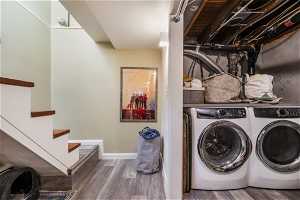 Washroom featuring hardwood / wood-style floors and independent washer and dryer