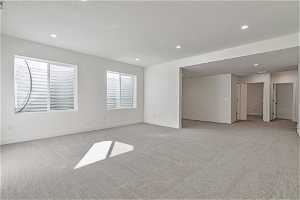 Spare room with light colored carpet and a textured ceiling