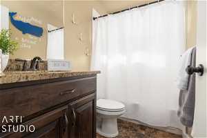Full bathroom featuring tile flooring, shower / tub combo with curtain, toilet, and large vanity