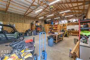 Garage featuring a workshop area and a garage door opener