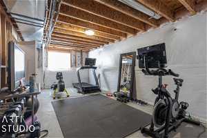 Exercise room with concrete flooring Could be a 4th bedroom