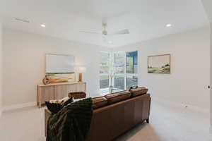 Living area featuring light carpet, recessed lighting, and a ceiling fan