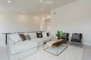 Living room featuring light carpet, recessed lighting, and ceiling fan