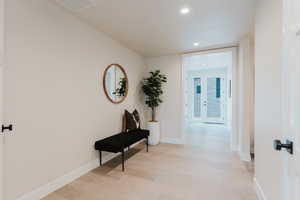Corridor with recessed lighting and light wood-style floors