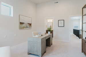 Office featuring light carpet and a high ceiling