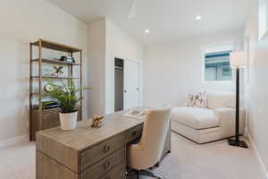 Office area with light colored carpet, vaulted ceiling, and recessed lighting