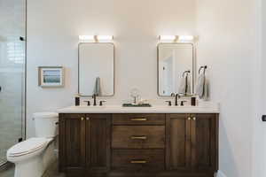 Bathroom with double vanity and a shower stall