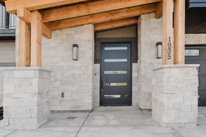 Doorway to property featuring stone siding