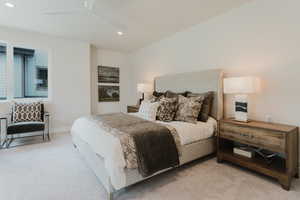 Bedroom with light carpet, recessed lighting, and a ceiling fan