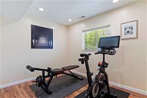 Workout area featuring wood-type flooring