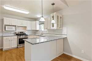 Freshly Updated Kitchen with Granite Countertops and Gas Range