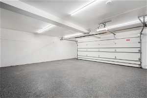 Large two car garage with recently finished epoxy floors and tons of storage