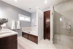Primary bathroom with separate tub and shower, double sinks and linen closet