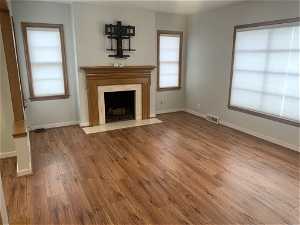 Unfurnished living room with a wealth of natural light and hardwood / wood-style flooring