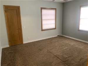 Unfurnished bedroom 1 featuring a healthy amount of sunlight and carpet flooring